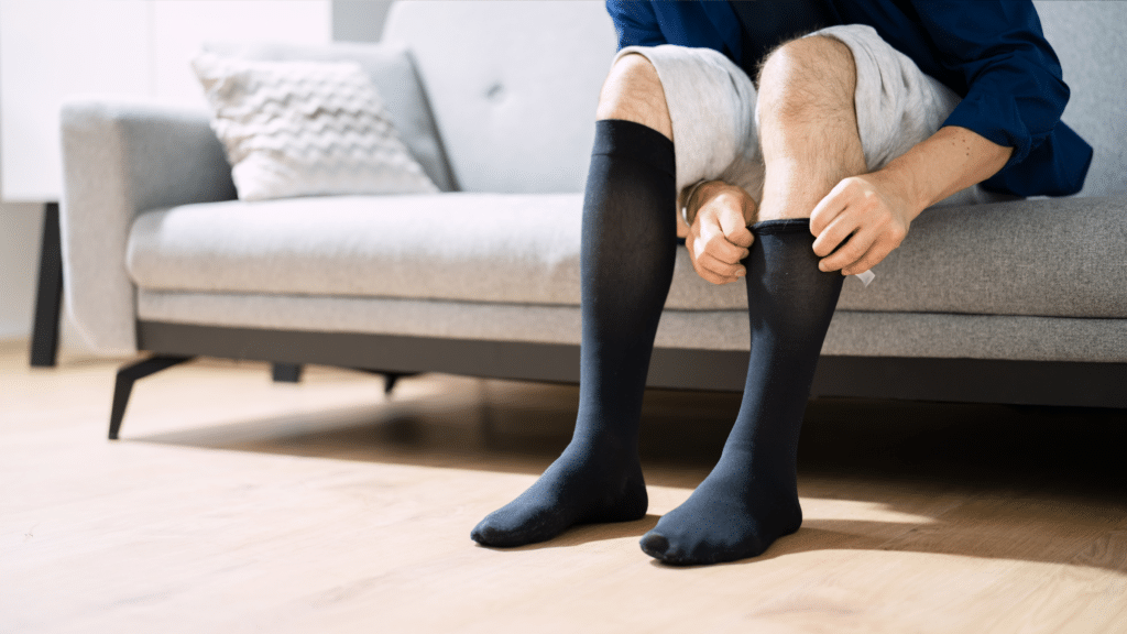 Using compression socks to improve circulation and reduce restless leg syndrome symptoms in the lower legs.