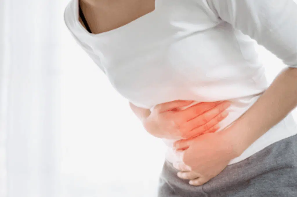 Hands on stomach with pain highlight, PMS