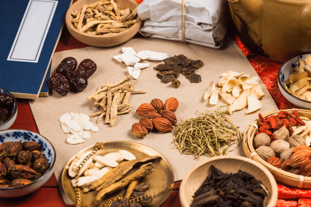 Assorted Chinese herbs arranged on a table for traditional constipation support