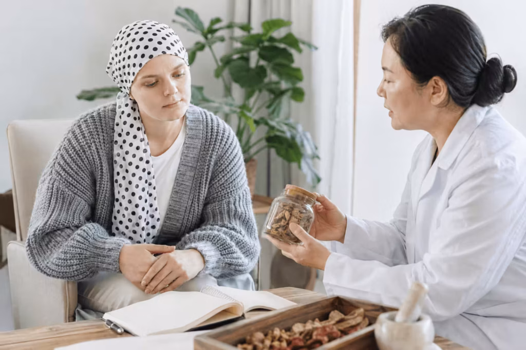 TCM practitioner discussing Chinese herbs with a cancer patient after chemotherapy