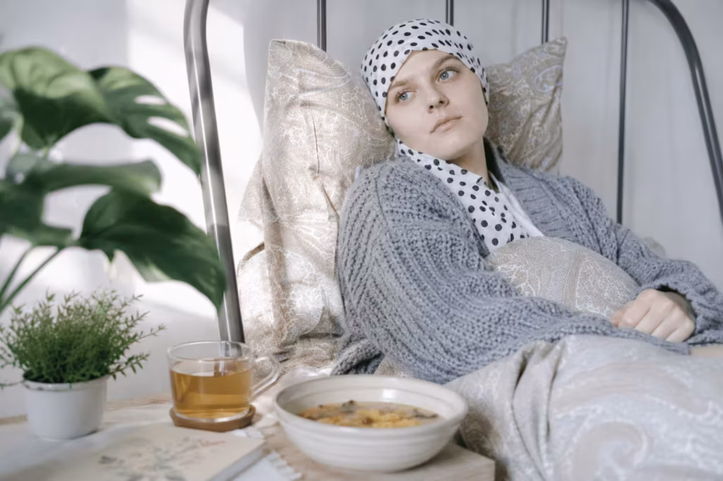 Woman undergoing cancer treatment resting with warm tea and nourishing food